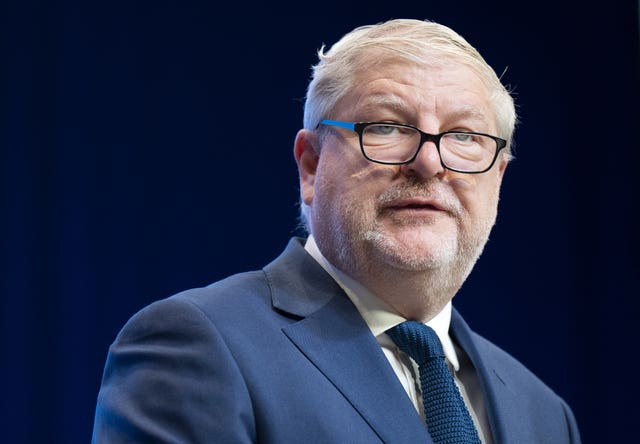 Head and shoulders photo of Angus Robertson wearing glasses