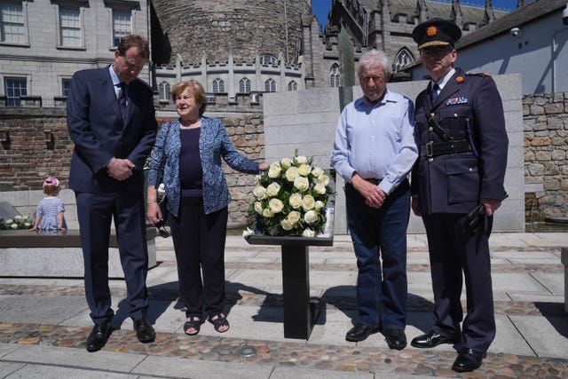 (l to r) Minister for Justice Jim O’Callaghan, Breda Flatley (mother of Kevin Flatley), Michael Flatley (father of Kevin Flatley) and Garda Commissioner Drew Harris pose alongside a wreath on the annual Garda memorial day 