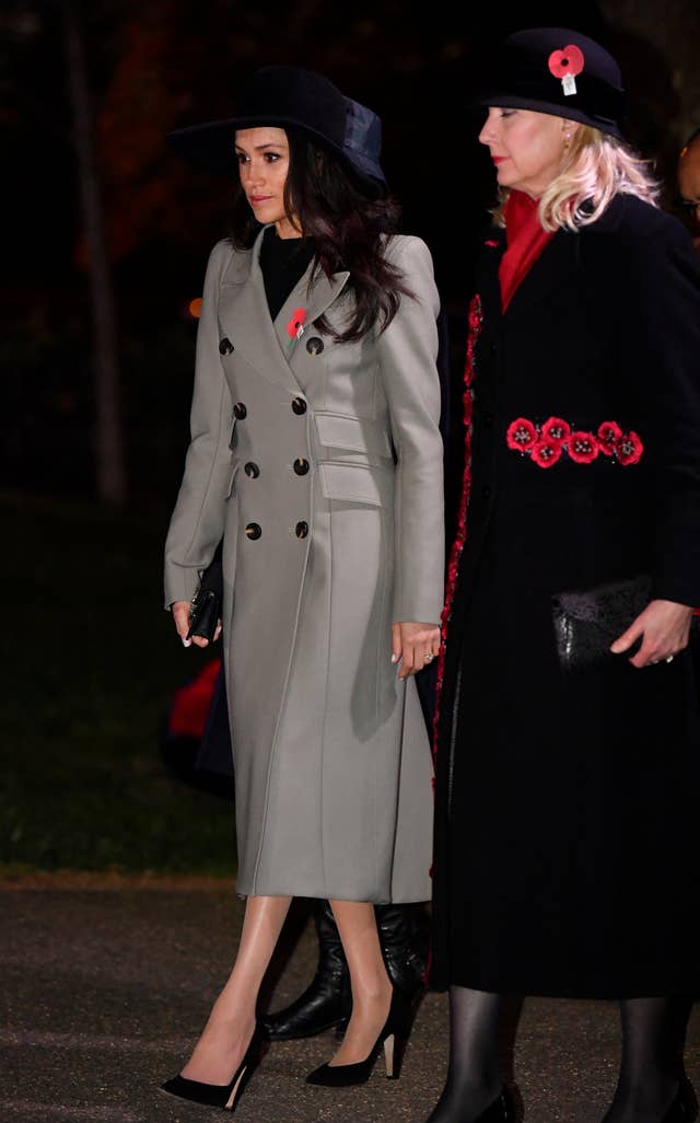Ms Markle wore a grey coat and large brimmed hat (Toby Melville/PA)