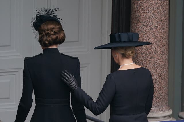 Sophie places her hand on the the Princess's back as they leave 