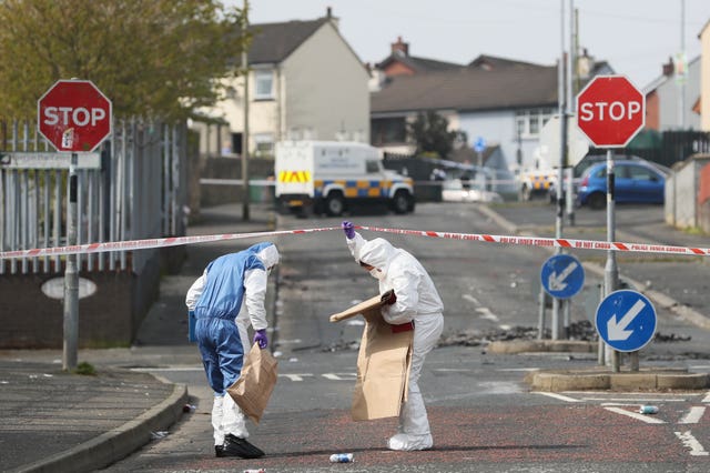 Police forensic officers at the scene in Londonderry where Lyra McKee was shot and killed