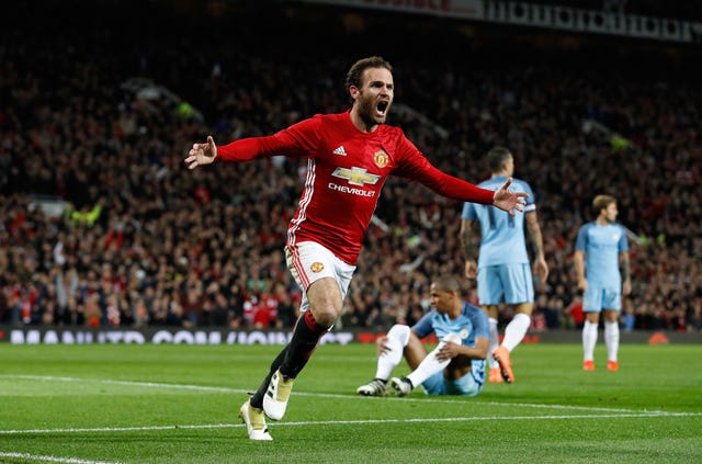 Juan Mata celebrates scoring the winner against Manchester City