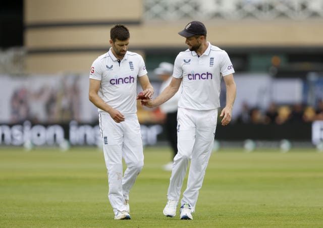 England’s Mark Wood, left, and Chris Woakes talking