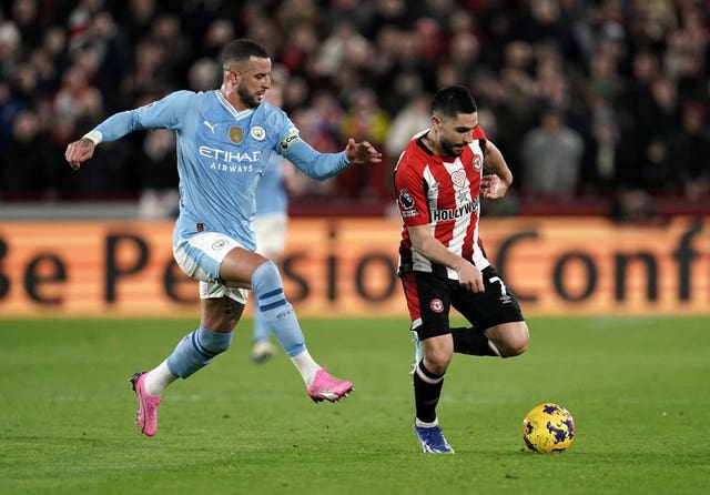 Brentford's Neal Maupay, right, shields the ball from Manchester City's Kyle Walker