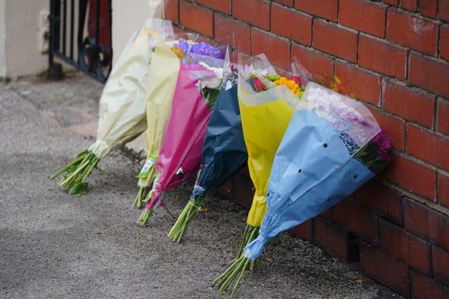 Flowers propped up against a wall