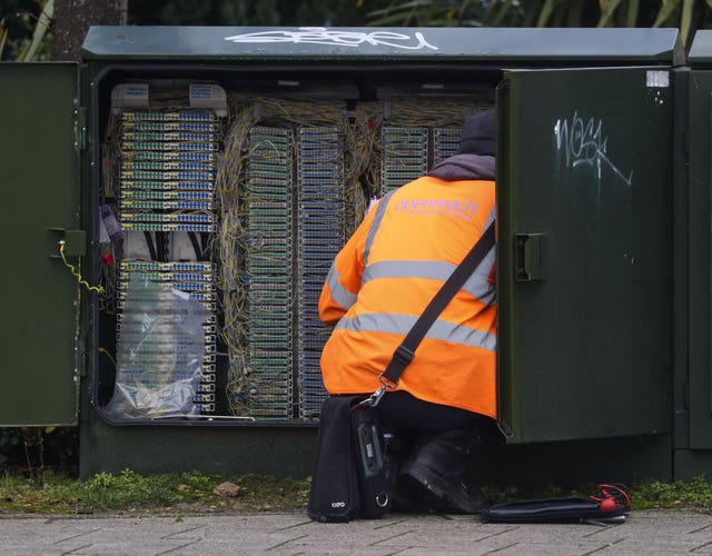 A telecoms worker examines a network