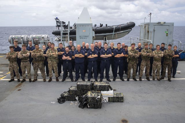 Sailors, Royal Marines and the US Coast Guard team on board support ship RFA Argus in the Caribbean Sea