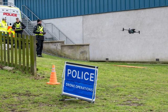 Police drone taking off in a grassy area