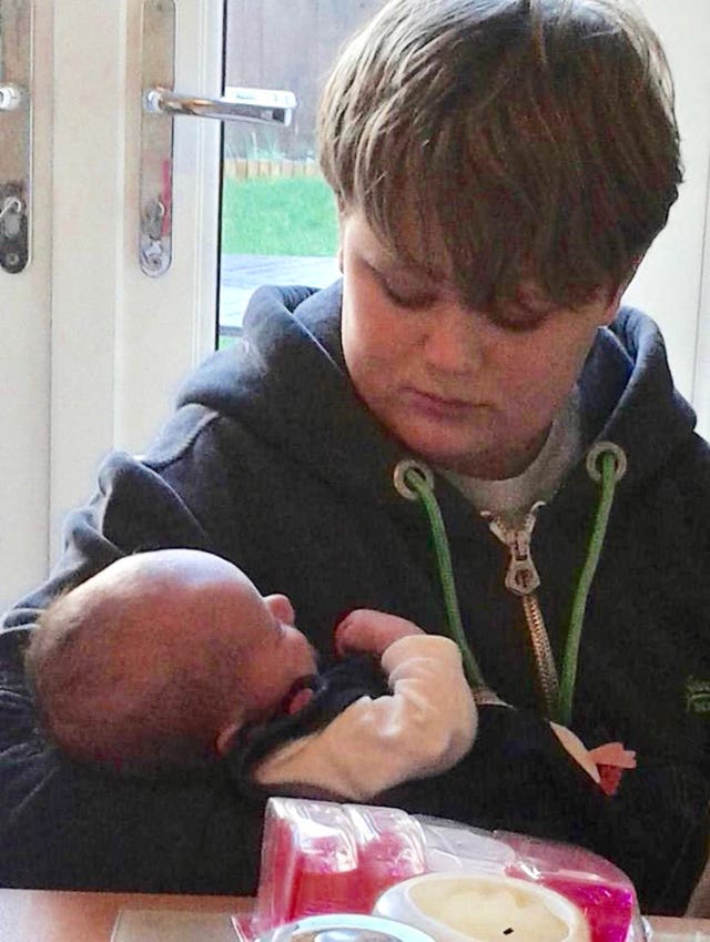 Harry Dunn, pictured in January 2014, with his newborn niece Lola Harber (Family Handout/PA)