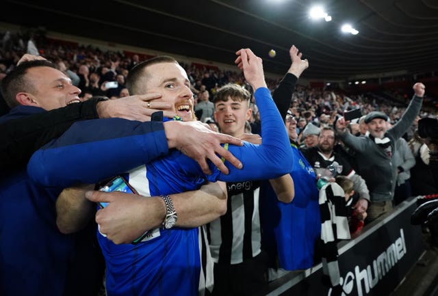 Grimsby's players celebrated a memorable upset with their travelling supporters