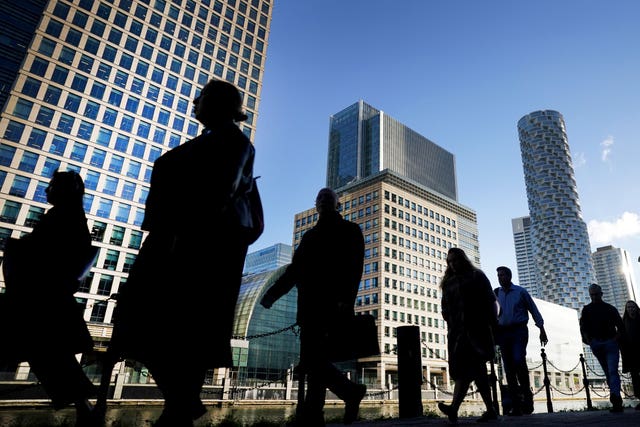 Office workers and commuters walking through Canary Wharf (Victoria Jones/PA)