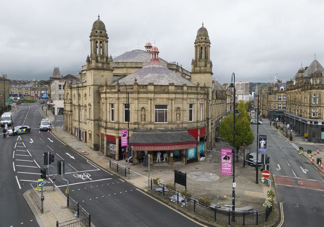 Police activity outside the Victoria Theatre in Fountain Street, near to the scene of a triple stabbing in Commercial Street in Halifax, West Yorkshire