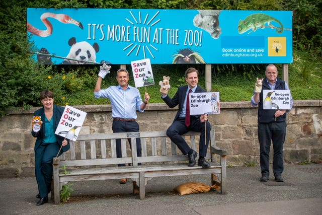 Politicians with animal puppets outside zoo