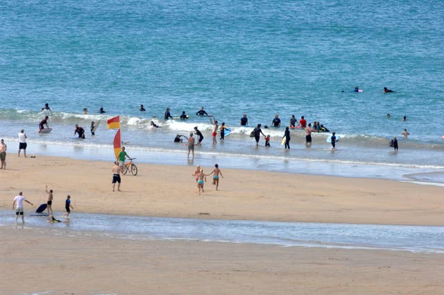 Surfers at Fistral Beach, Newquay, Cornwall (Barry Batchelor/PA)