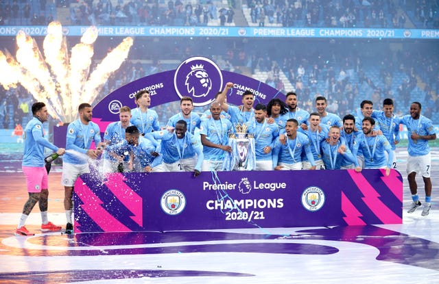 Manchester City players celebrate with the trophy