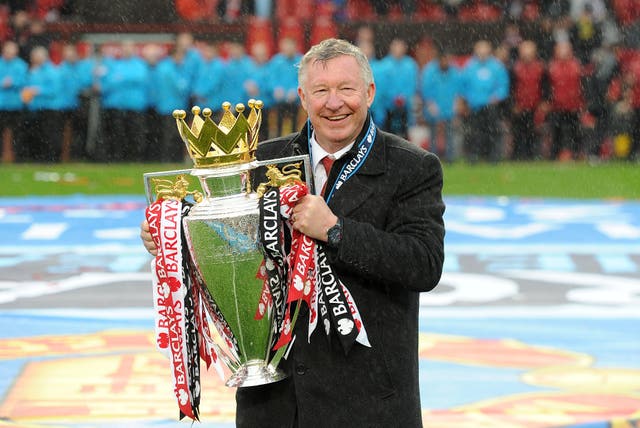 Sir Alex Ferguson lifts the 2012-13 Premier League trophy