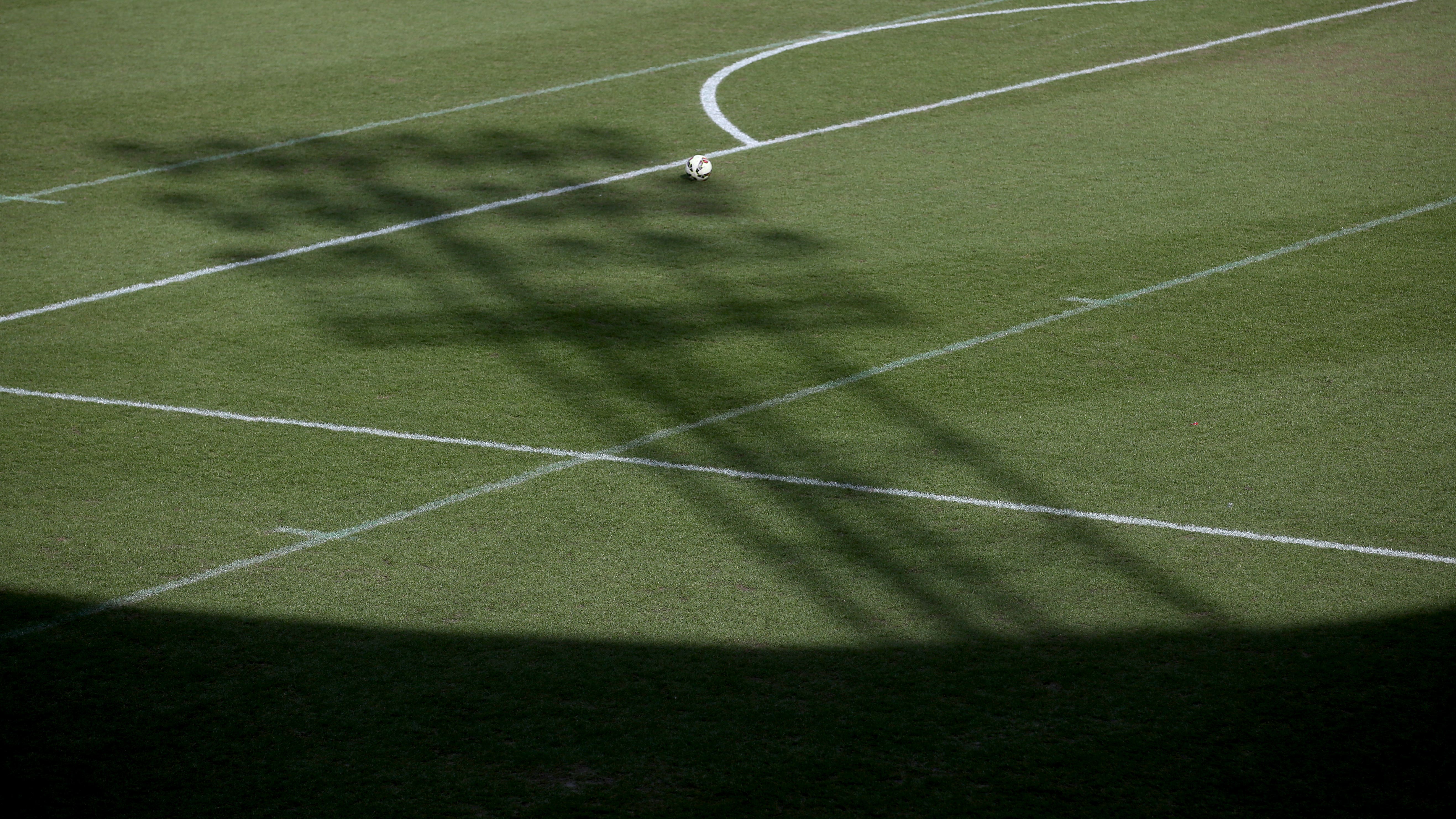 The shadow of a floodlight on the pitch at the Keepmoat Stadium