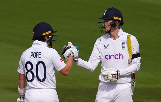 Ollie Pope (left) and Zak Crawley (right) share a handshake batting for England.
