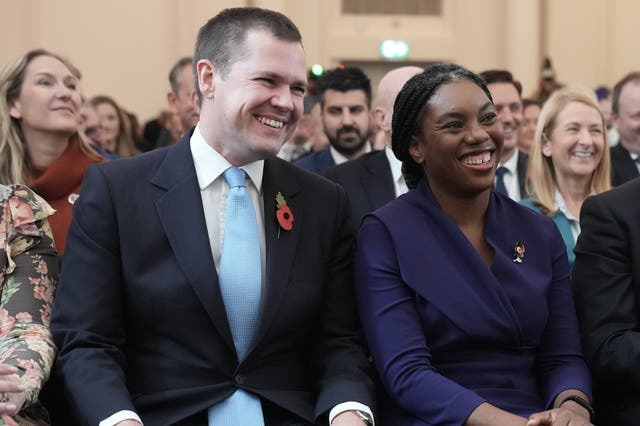 Kemi Badenoch sitting with Robert Jenrick