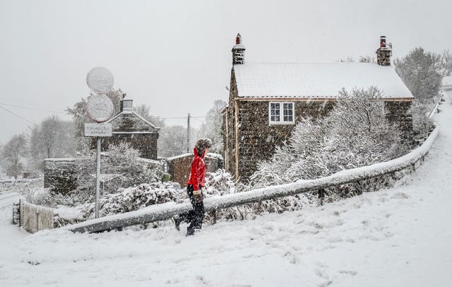 A girl walking in the snow in Whitby. 