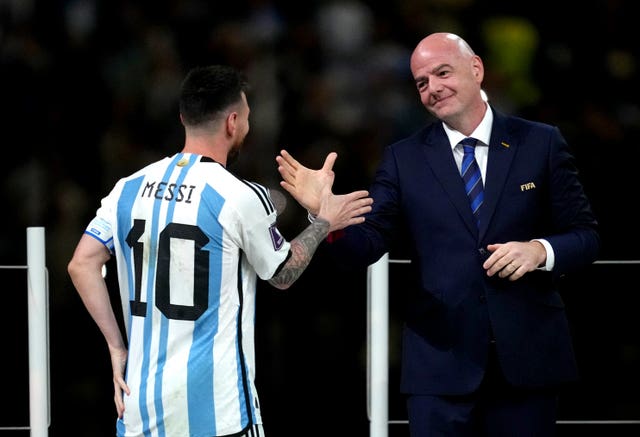 Lionel Messi (left) shakes hands with FIFA President Gianni Infantino