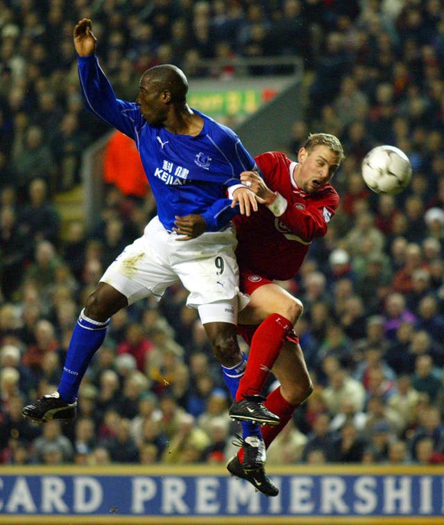 Liverpool’s Stephane Henchoz challenges Everton's Kevin Campbell