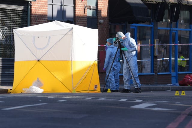 Forensic officers at the scene in Brixton Road