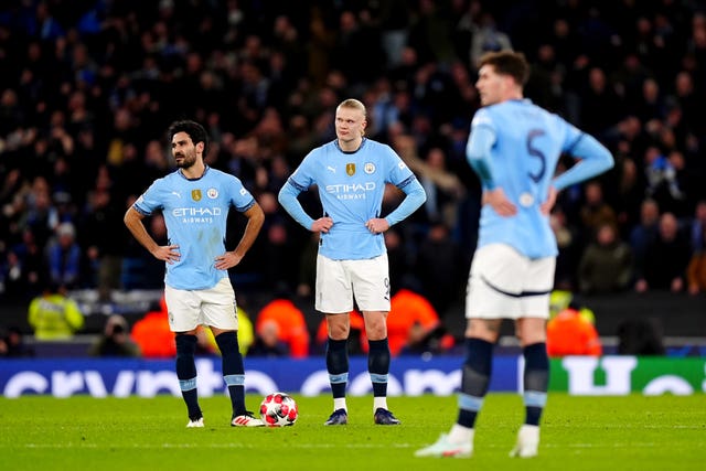 Manchester City's Ilkay Gundogan, Erling Haaland and John Stones stand with hands on hips in frustration