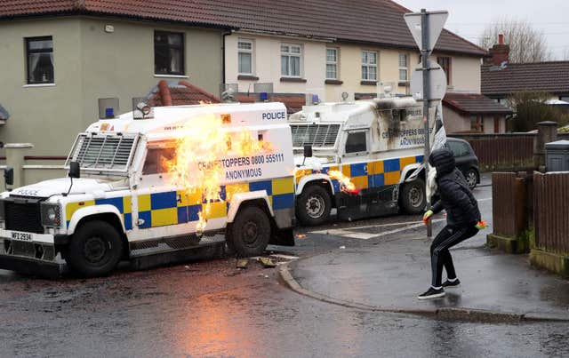 Youths attack police vehicles as they try to stop the unregistered parade (Niall Carson/PA)