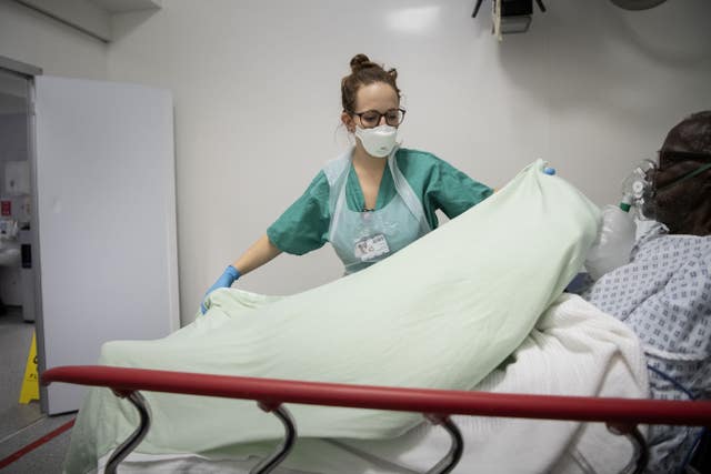 A staff nurse tends to a patient in the Emergency Department 