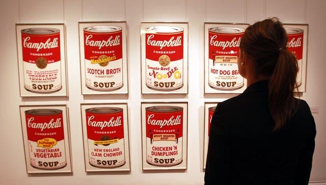 Sotheby’s staff member Isabelle Brown looks at a set of Andy Warhol’s Campbell’s Soup screenprints in London (Sean Depsey/PA)