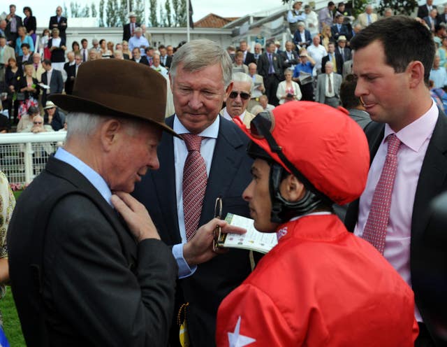 Sir Alex Ferguson listens as Barry Hills (left) and his son Charlie (right) talk to jockey Silvestre de Sousa at York