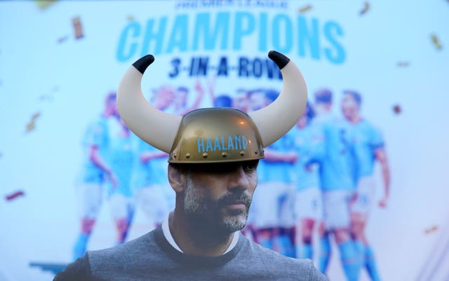 A cardboard cut-out of Manchester City manager Pep Guardiola wearing an Erling Haaland viking helmet