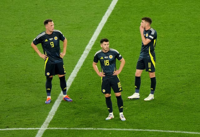 Scotland’s Lawrence Shankland (left), Lewis Morgan and Ryan Christie show their dejection after conceded a last minute goal against Hungary