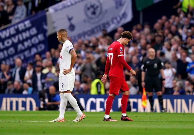 Curtis Jones, right, leaves the field after his red card against Tottenham