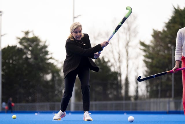 The Duchess of Edinburgh takes shots against goalkeeper Miriam Pritchard during a visit to England Hockey