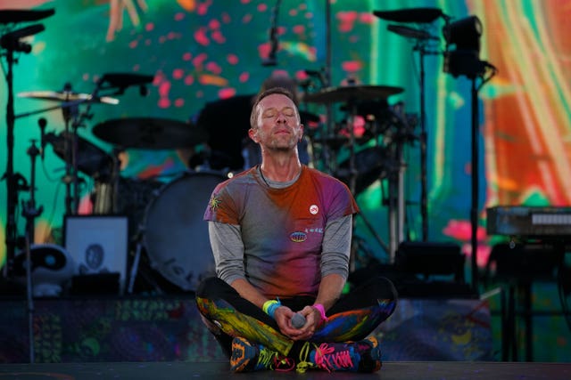 Members of Coldplay performing on stage