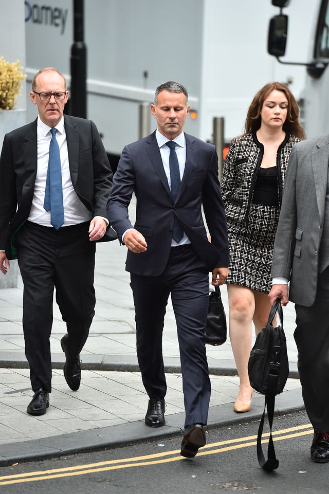 Former Manchester United footballer Ryan Giggs (centre) arrives at Manchester Crown Court