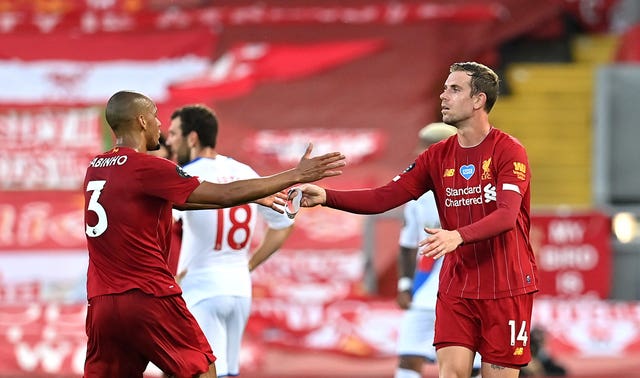 Fabinho and Liverpool captain Jordan Henderson greet each other on the pitch