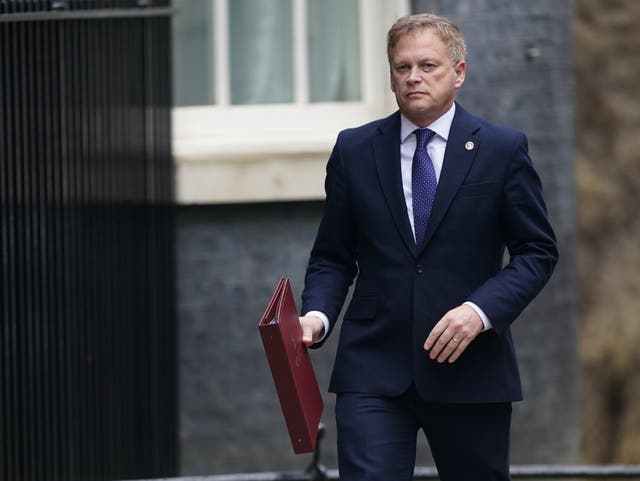 Defence Secretary Grant Shapps walking and holding a file