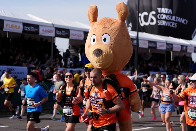 A runner with a giant teddy on his back