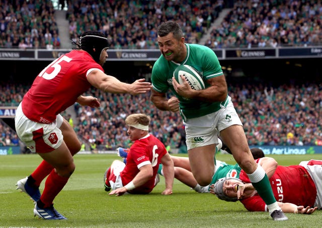 Rob Kearney goes past Wales' Leigh Halfpenny to score Ireland's fourth try in the 19-10 victory