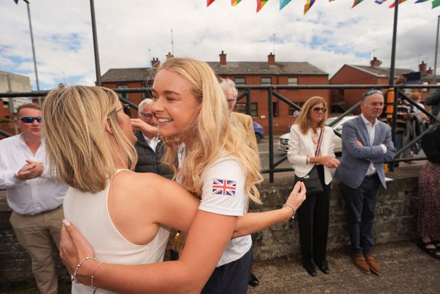 Two women hug