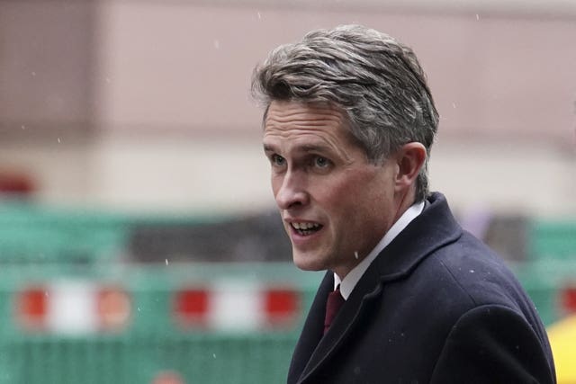 Sir Gavin Williamson walking along the street