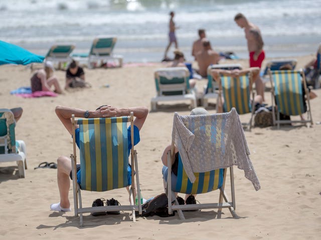 People enjoy the sunshine on the beach in Bournemouth, Dorset