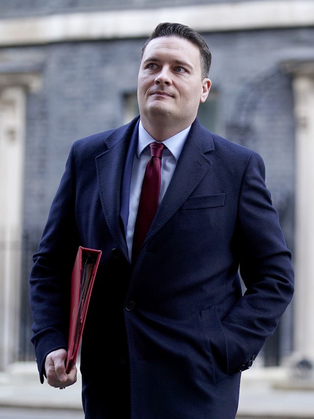 Wes Streeting walking on Downing Street, with his red ministerial folder under his right arm