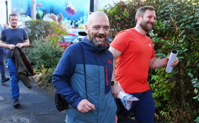 People smiling as they leave prison