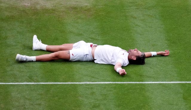 Cameron Norrie laying on the court 