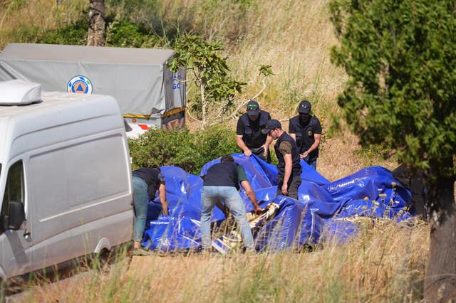 Officers pack up a tent 