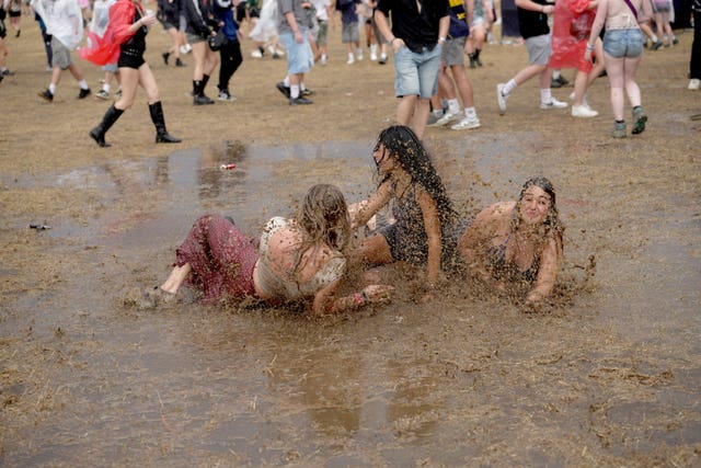 Festivalgoers frolicking in the rain during the Reading Festival at Little John’s Farm, Reading, Berkshire
